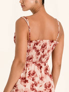 Side profile of red floral maxi dress with adjustable straps and flowy skirt