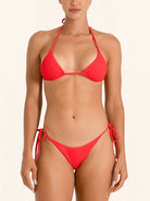 Red tie side bikini bottom with cheeky cut and minimal coverage.