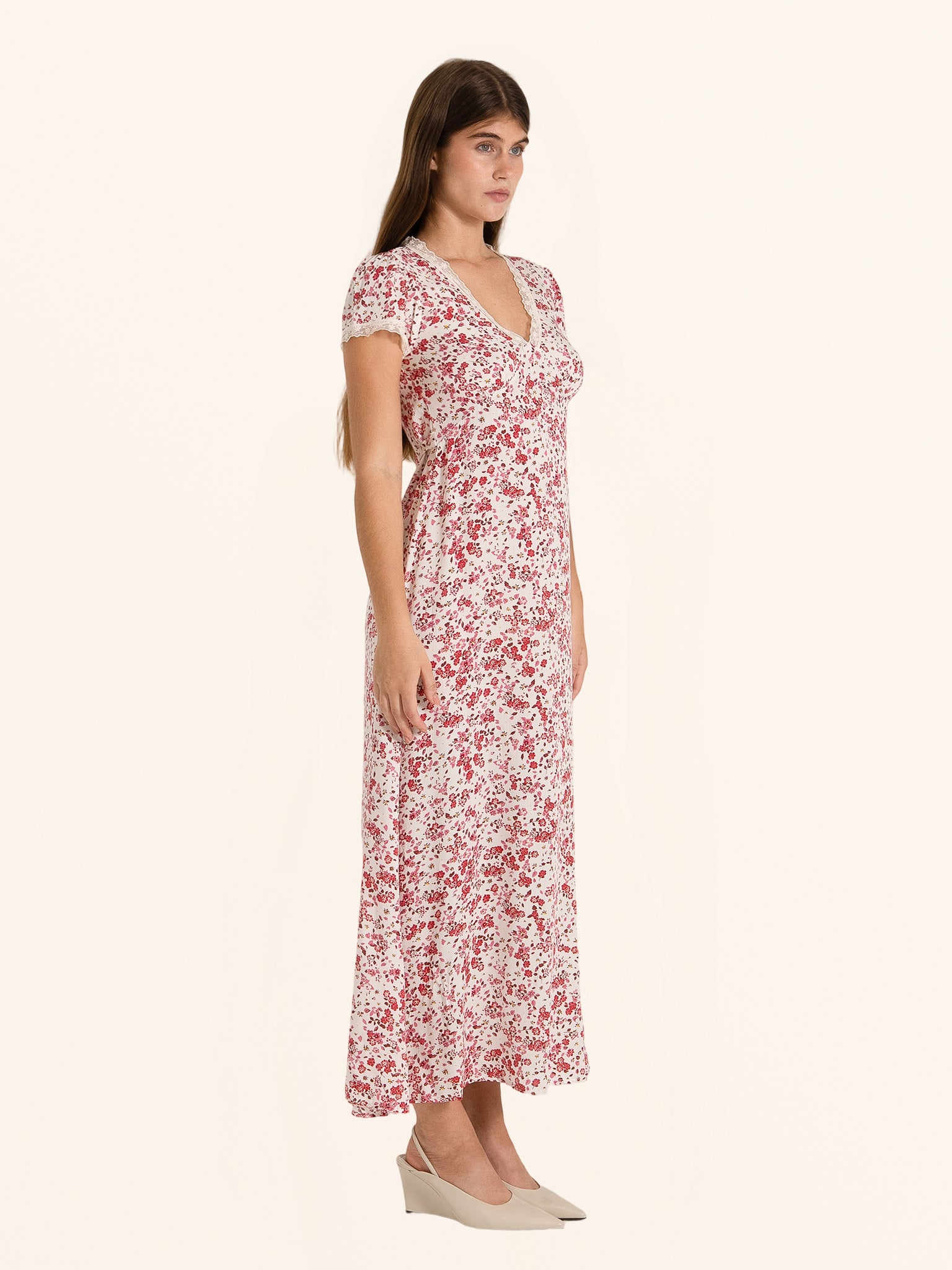 Side profile of red and white floral midi dress with flowy hemline