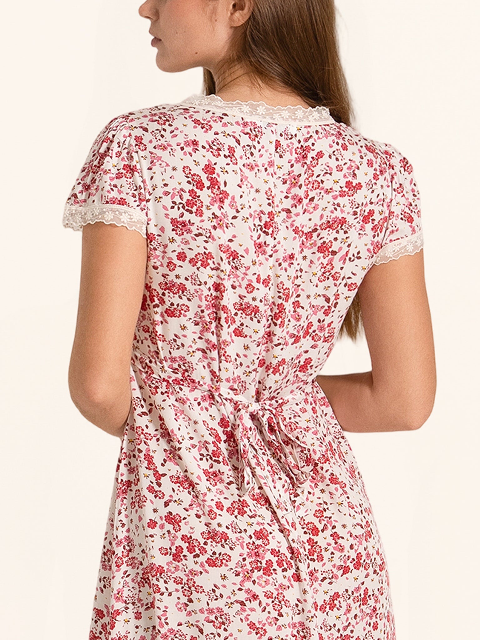 Back view of red and white floral midi dress with tie waist and short sleeves