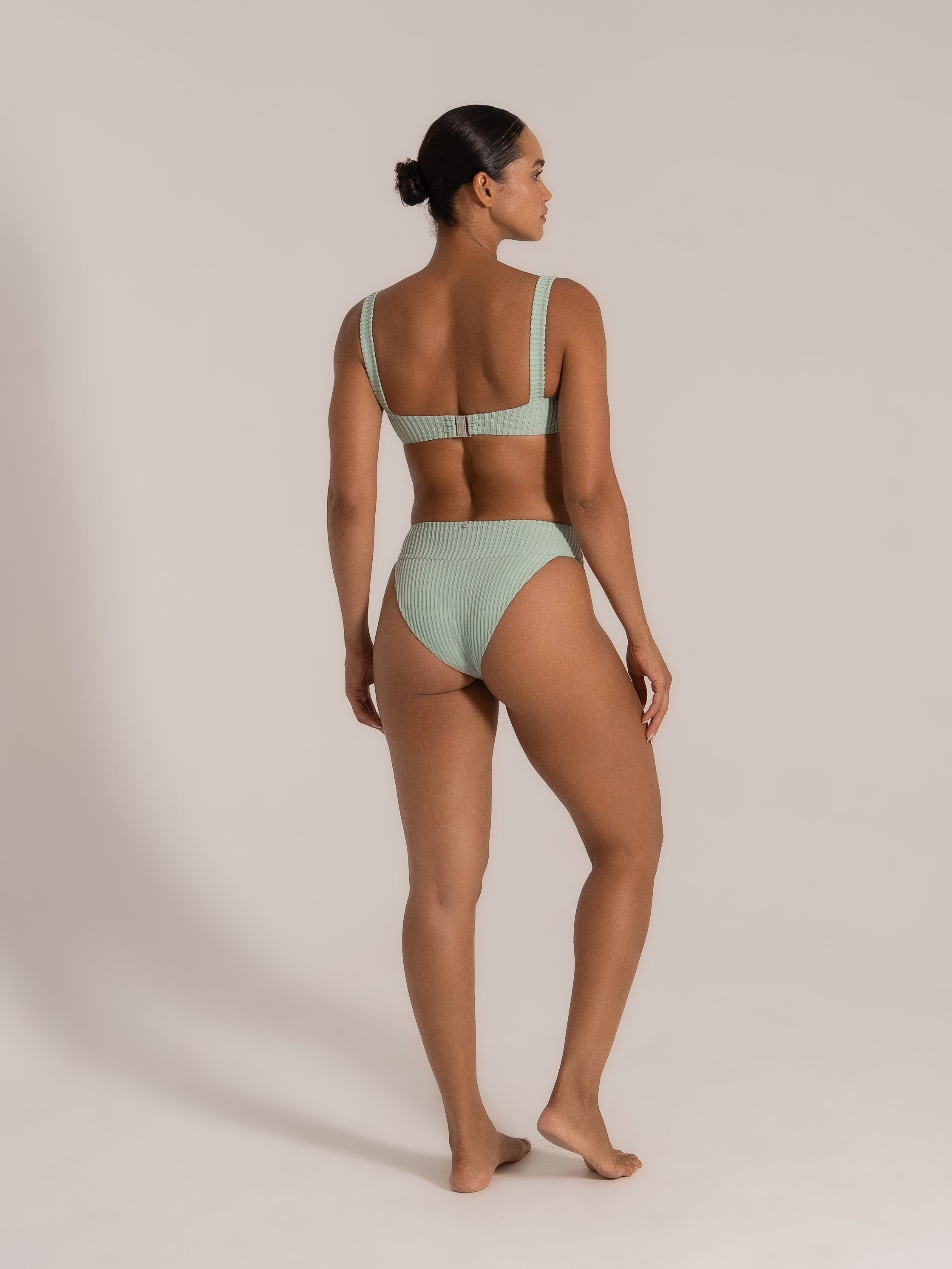 Side-back angle of a mint green ribbed bikini set, featuring square back and full coverage.