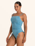 Blue ruched one piece swimsuit featuring side tie accents.