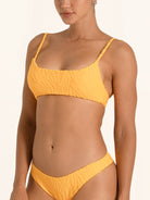 Side angle of mustard yellow square neck bikini top showing cropped fit design.