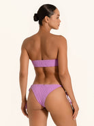 Back side view of purple strapless bandeau bikini top styled with tie side bikini bottom.