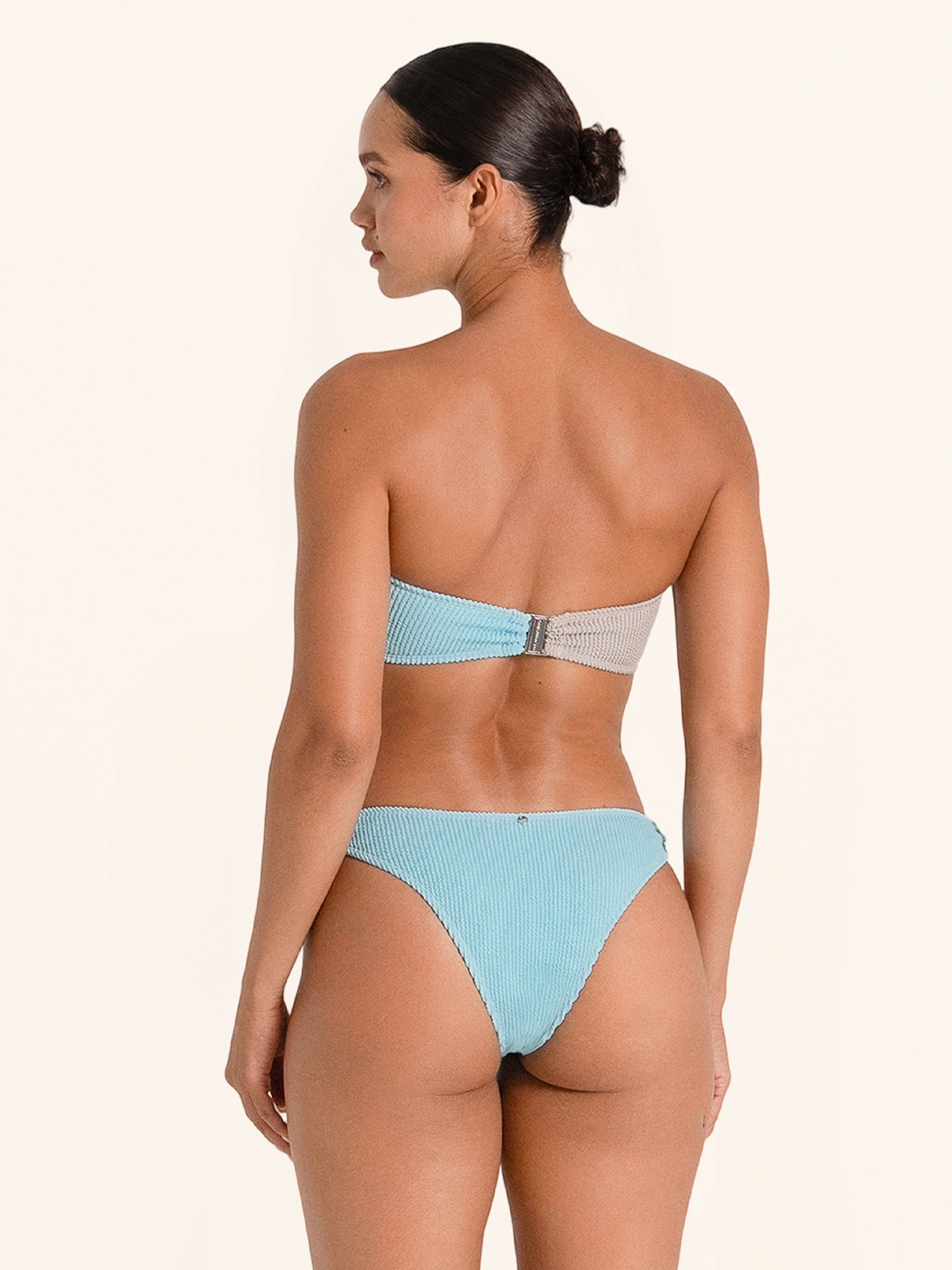 Stylish blue and grey bikini bottom with unique side ring and mid-rise fit.
