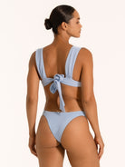 Back view of textured baby blue bikini with thick shoulder straps and large bow tie