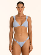 Front view of baby blue textured triangle bikini set on model