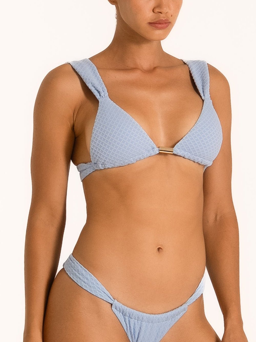 Model wearing baby blue textured triangle bikini set with tie-side bottom