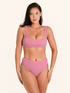 Trendy pink bikini top with thick shoulder straps and textured detailing.