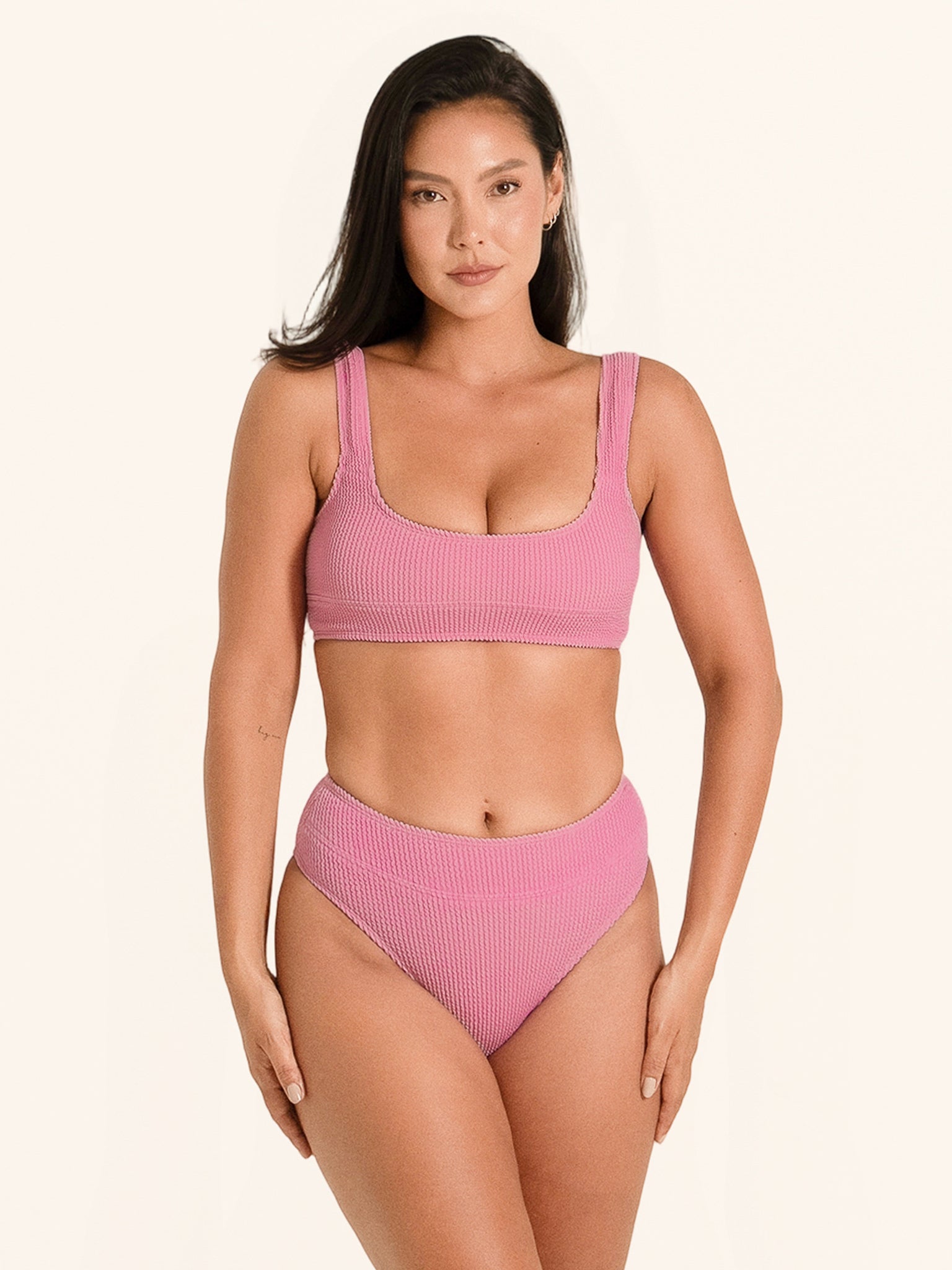 Trendy pink bikini top with thick shoulder straps and textured detailing.