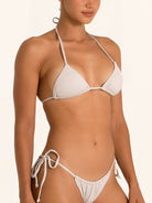 Side angle of shimmer silver triangle bikini top with plunging neckline and glossy finish.
