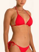 Side pose of red triangle bikini top with plunging neckline and slim straps.