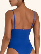 Close up back view of blue textured V neck one piece swimsuit with scoop back.