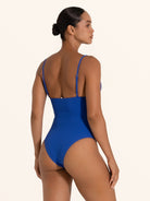 Back view of blue textured V neck one piece swimsuit with adjustable shoulder straps.