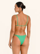 Vibrant green bikini bottom with bold summer look.