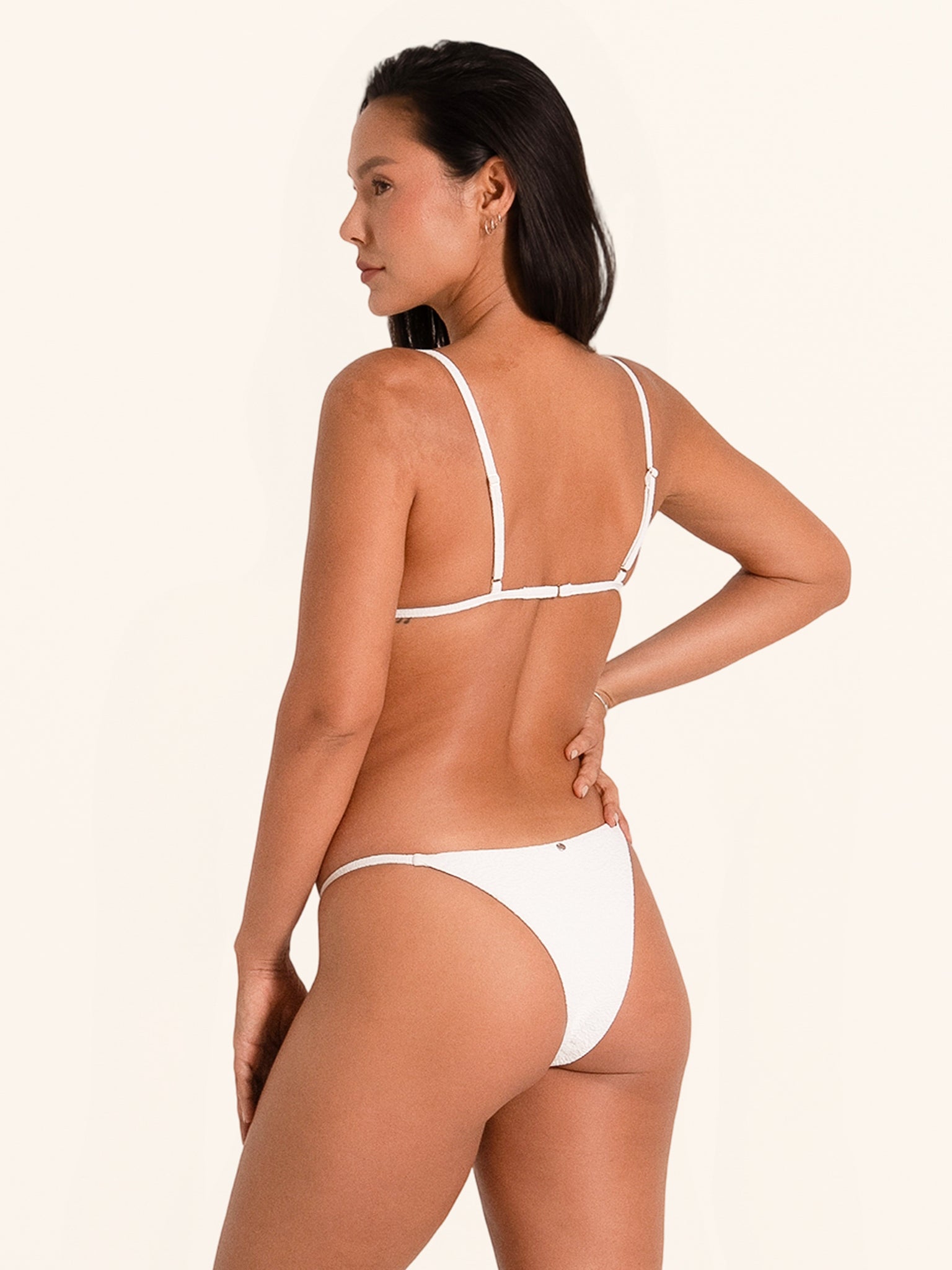 White adjustable bikini top with triangle cups and slim straps.