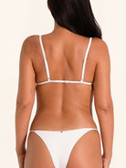 White halter bikini top in minimal swimwear style.