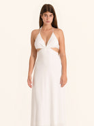 Front view of white halter cut out maxi dress with tie back design
