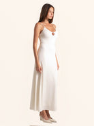 Side angle look of white midi dress featuring keyhole detail