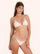 Minimal white string swimwear bottom with sleek beach look.