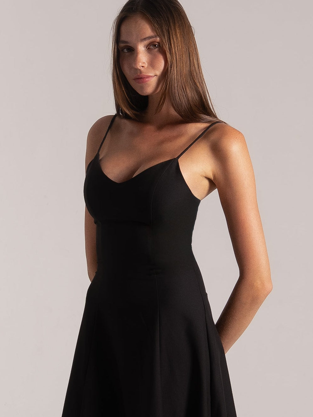 Ocean Mystery black pleated midi dress with V-neck and spaghetti straps - elegant flared skirt silhouette.