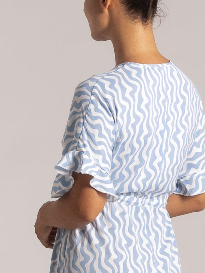 Back view of Ocean Mystery blue & white wave print maxi dress with flutter sleeves and cinched waist - summer fashion.