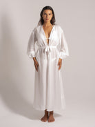 Ocean Mystery’s snow-white crinkle-textured kimono bathrobe with deep V-neck over bikini. Long belted sleeves and ankle-length flow for beach-resort transitional styling.