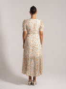 Ocean Mystery white floral midi dress with puff sleeves and cinched waist - back view summer outfit.