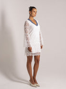 Ocean Mystery white lace dress with blue floral V-neck trim and long sleeves - elegant wedding guest attire.