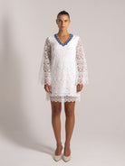 Ocean Mystery white lace dress with blue floral neckline, sheer long sleeves and knee-length hem - perfect wedding guest attire.
