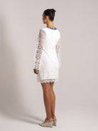 Ocean Mystery white lace mini dress with blue floral neckline and long sleeves - perfect wedding guest outfit with back detailing.