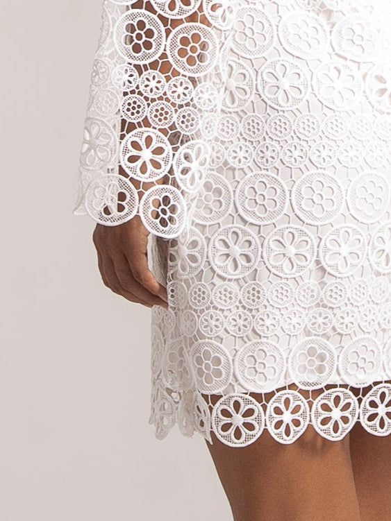 Ocean Mystery white lace mini dress with blue floral neckline and long sleeves - perfect wedding guest outfit with back detailing.