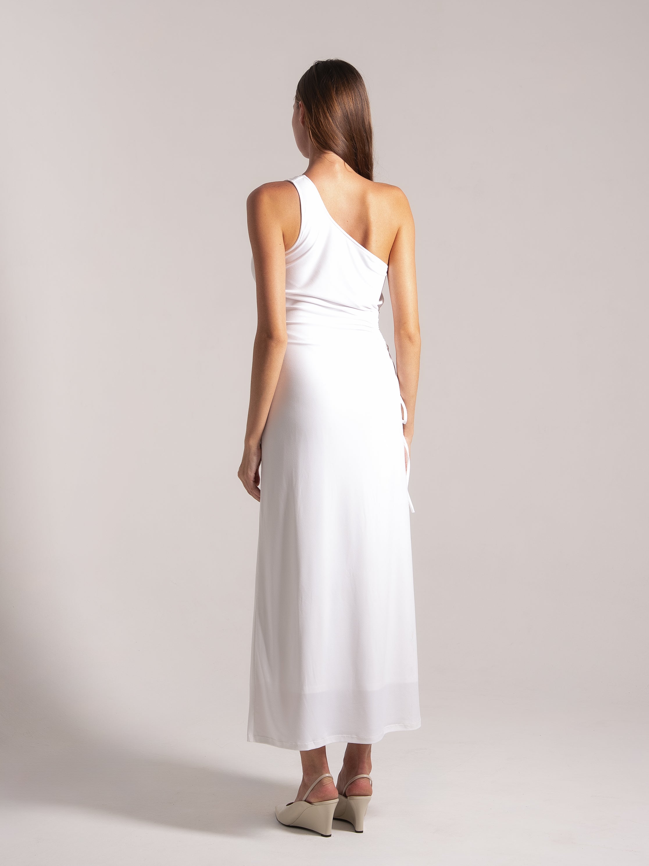 Ocean Mystery white one-shoulder maxi dress with cinched waist - elegant back view with wedge heels.