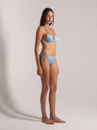 Light blue tie-dye bikini set with thin straps and beachy aesthetic
