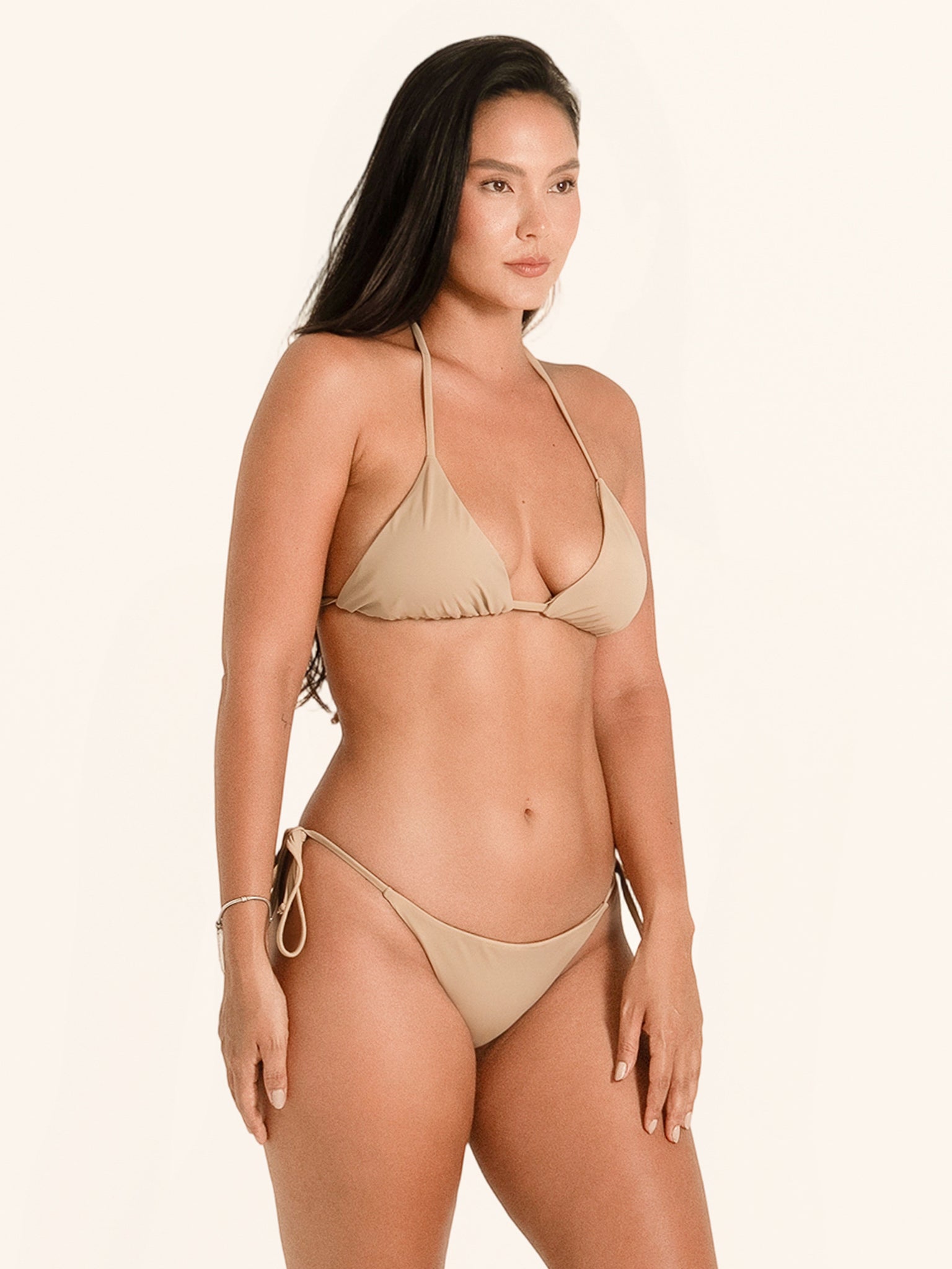 Adjustable tie side bikini bottom in beige with sleek silhouette.