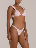 Angled view of high-rise bikini bottom in mint green with a flattering sculpted fit