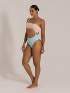 Side view of a color-block bikini with an asymmetrical neckline, cutout design, and pastel palette.
