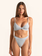 Front view of baby blue ribbed bikini top with crossover front and thin adjustable straps.