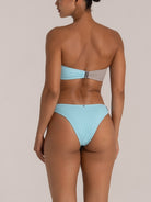 Back view of baby blue bikini bottom with high leg cut and subtle ring detail