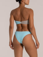 Angled back view of baby blue textured bikini bottom in stretch fabric