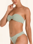 Minimalist bandeau bikini top in light green with clean strapless cut.