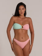 Strapless pastel bikini top with central ring shown from the front on model