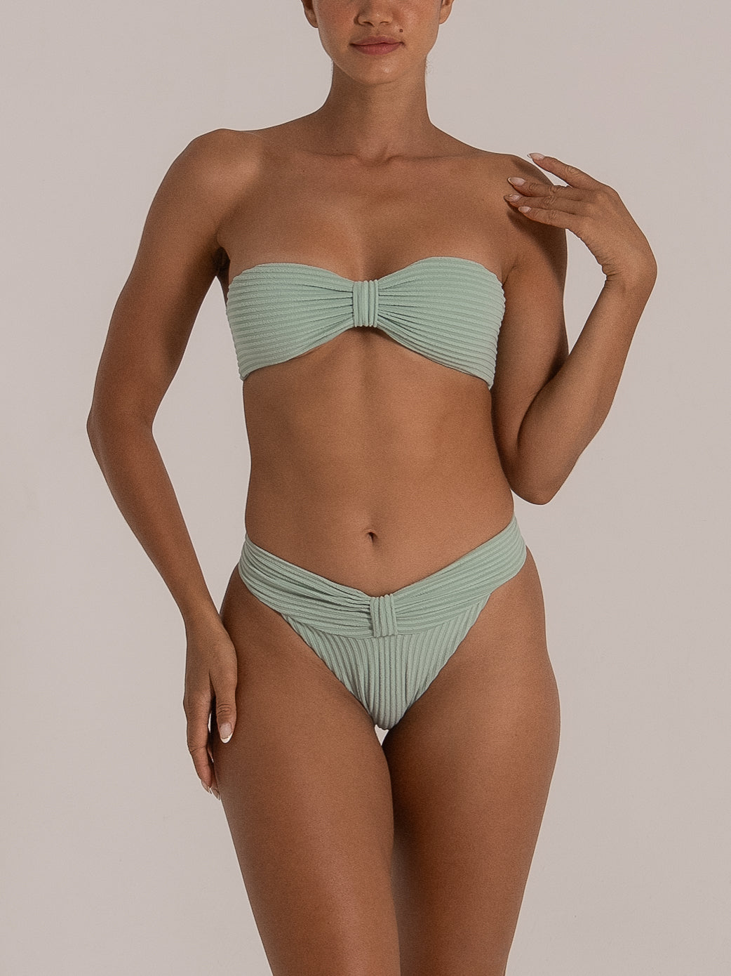 Front view of mint green bandeau set with twist-knot bikini bottom in ribbed material.