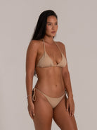 Side view of beige halter bikini set with string tie sides, showcasing a sleek and simple beachwear look