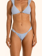 Close up of baby blue textured bikini bottom with soft stretch fabric and V shape design.