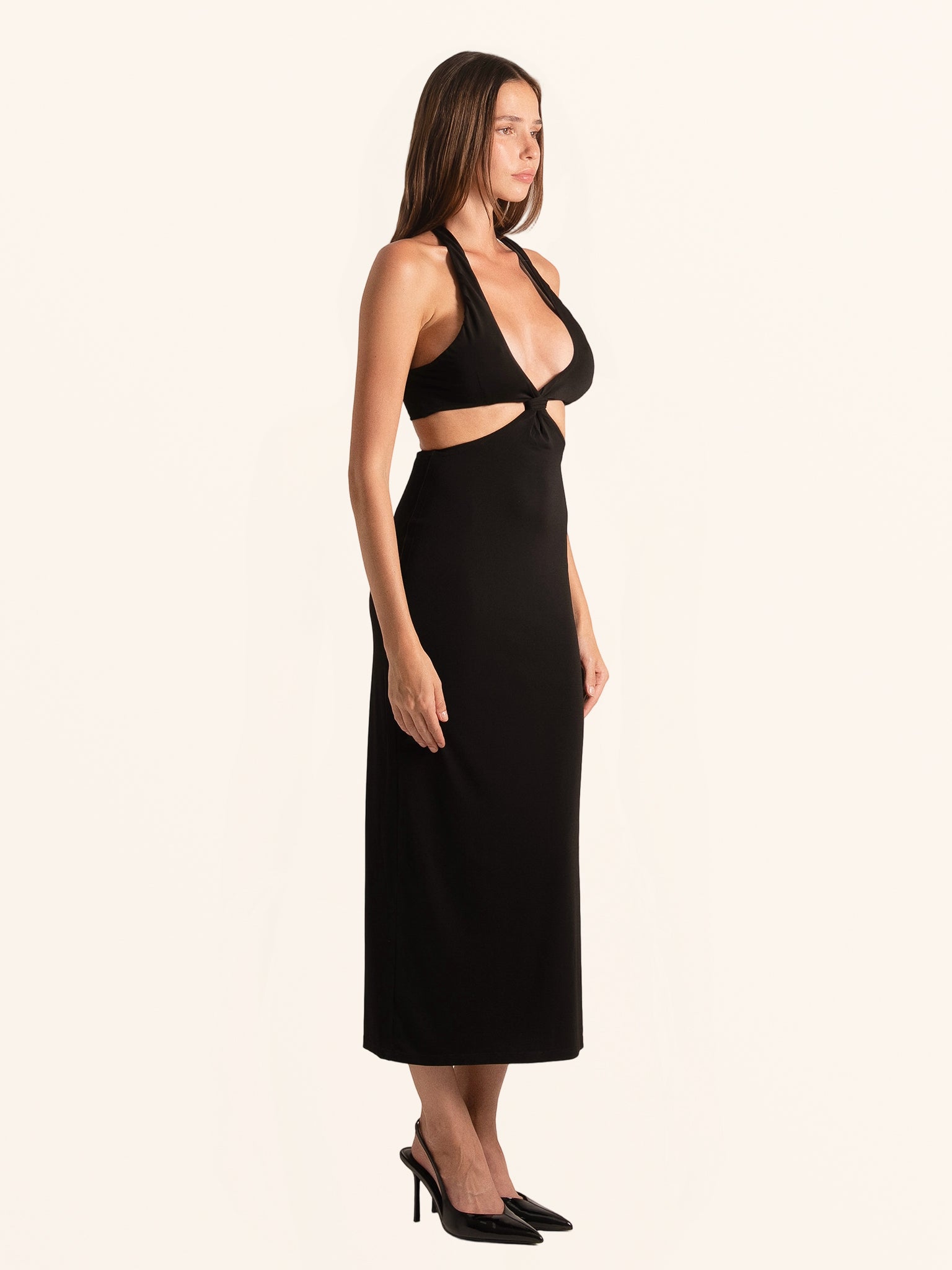 Full body side angle of black cut out maxi dress with bodycon fit