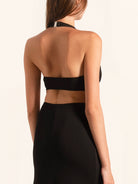 Back view of black deep V maxi dress with halter strap and open back