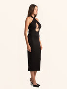 Rear side angle of black halter cut out dress with fitted silhouette