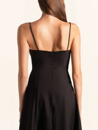 Back view of black midi dress with zipper closure and slim straps