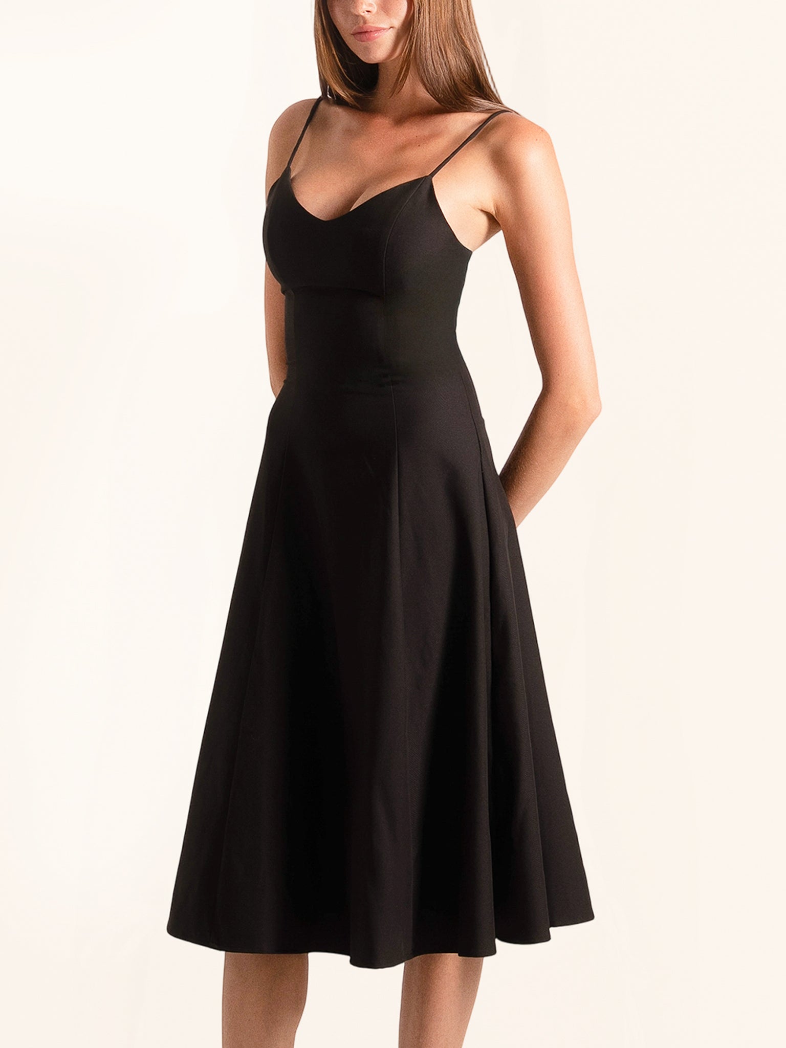 Side angle of black fit and flare midi dress with slim straps